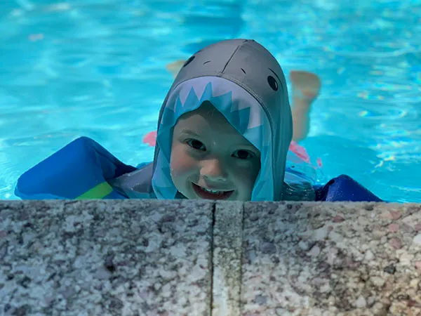 A young swimmer in a shark towel