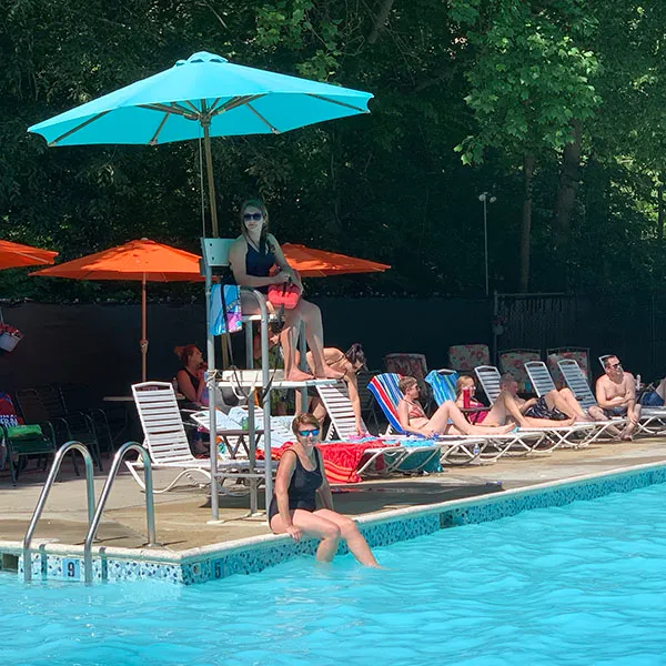 Lifeguard stand and pool deck with umbrellas